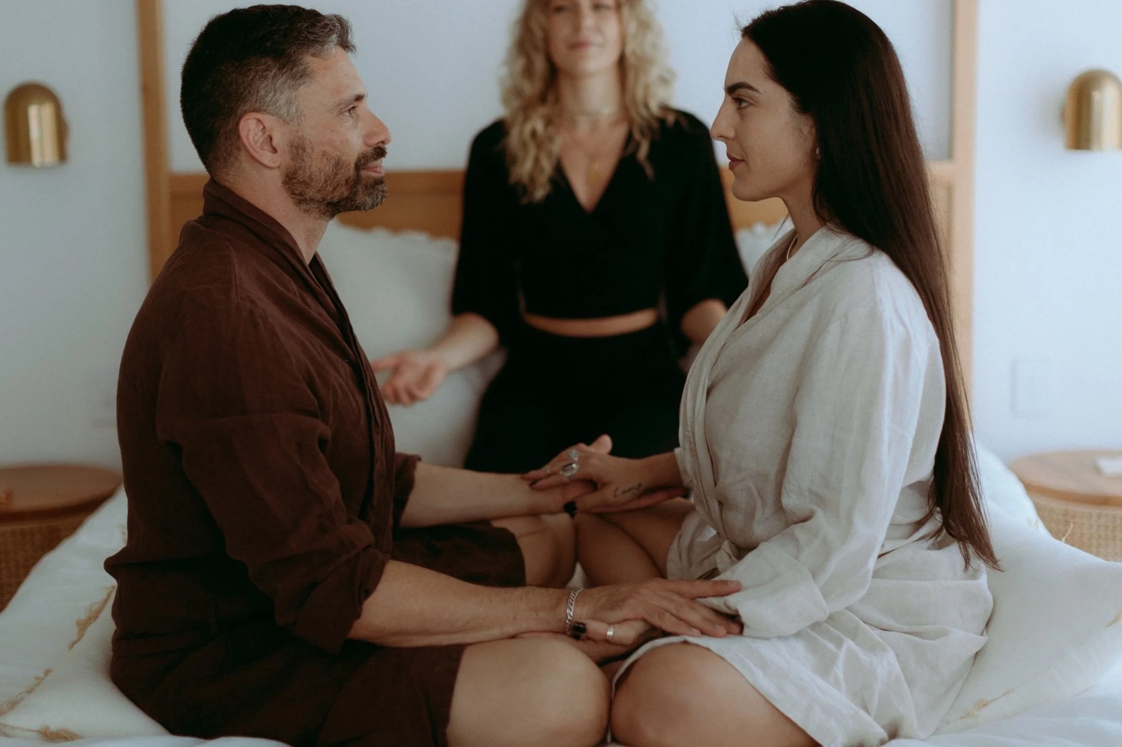 Two people in a calm, clothed practice session, working with breath and presence