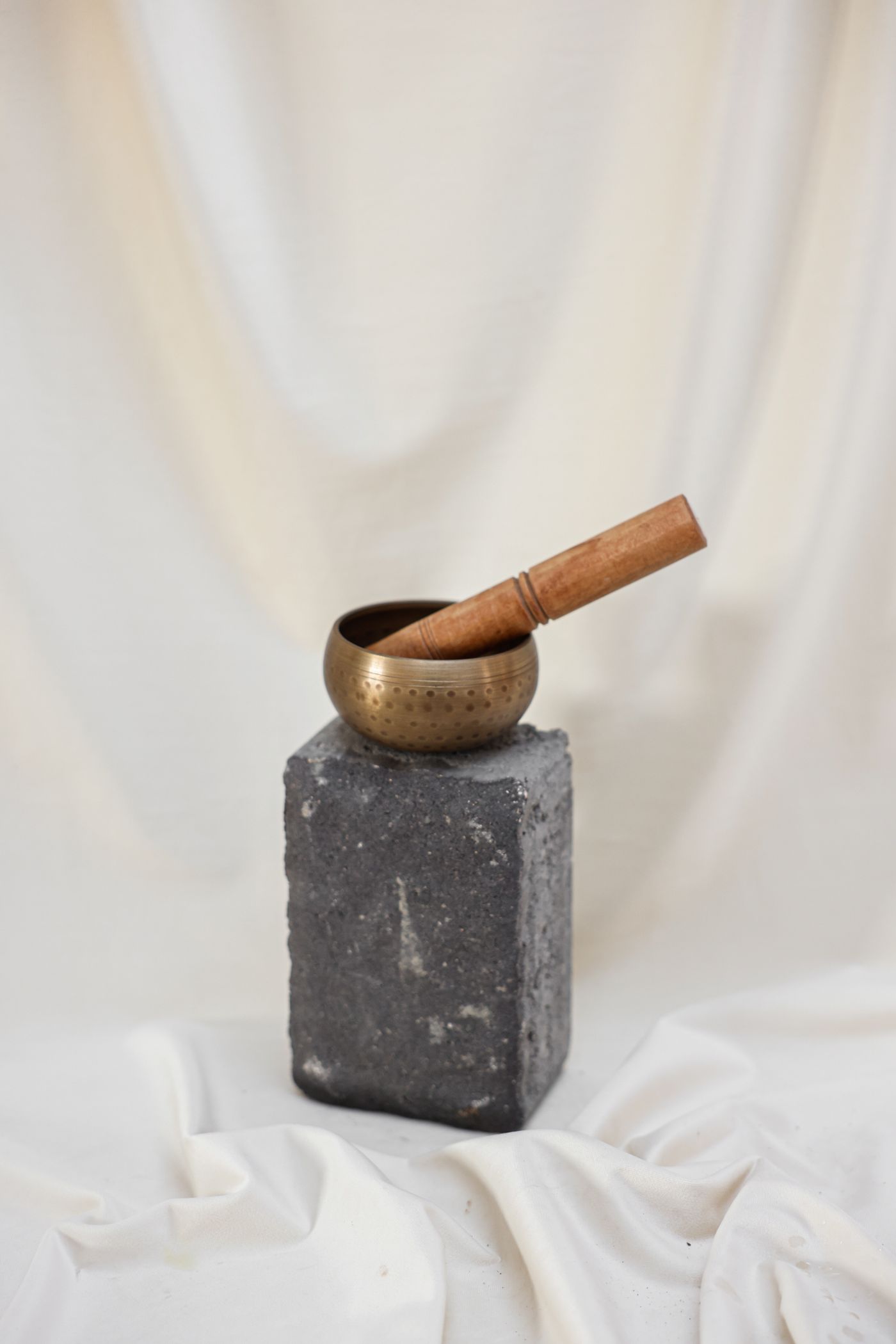 Singing bowl on a white background, an illustrative image for a quiet head-touch session.